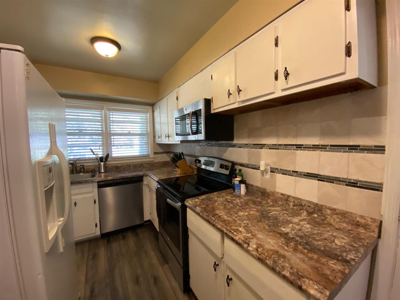 1265 Whitewater Road Memphis, TN 38117 - Photo 3 of 23 a kitchen with stainless steel appliances granite countertop a stove a sink and a microwave