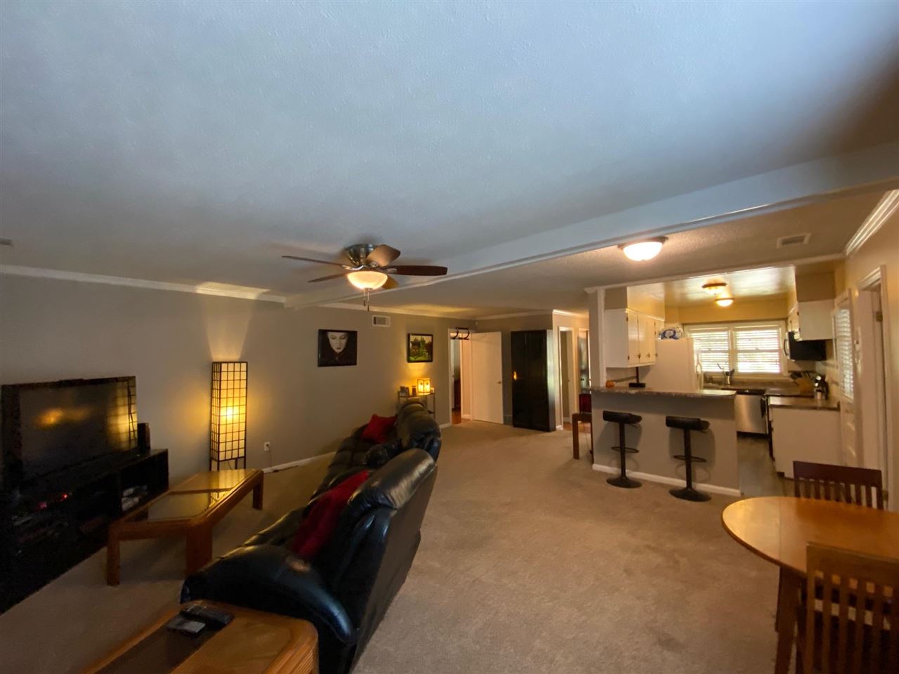 1265 Whitewater Road Memphis, TN 38117 - Photo 6 of 23 a living room with furniture gym equipment and a flat screen tv