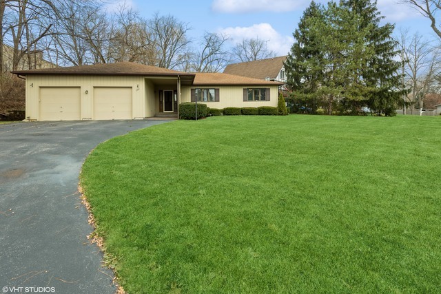 a front view of house with yard and green space