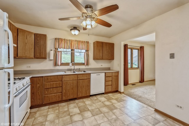 360 Mildred Avenue Cary, IL 60013 - Photo 12 of 18 a large kitchen with stainless steel appliances granite countertop a sink and cabinets
