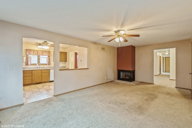 360 Mildred Avenue Cary, IL 60013 - Photo 9 of 18 an empty room with chandelier fan and windows
