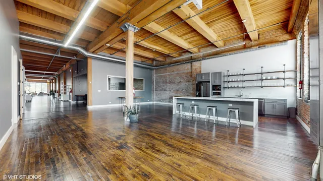an empty room with wooden floor and a window