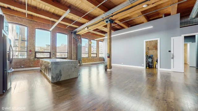 a view of a workspace with furniture and wooden floor