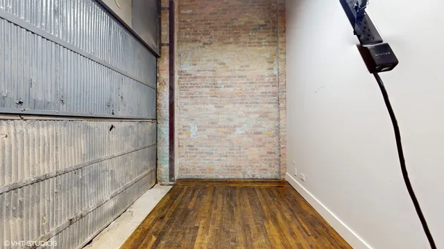 a dining room with wooden floor and a chandelier