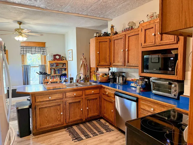 a kitchen with stainless steel appliances granite countertop a refrigerator and a stove