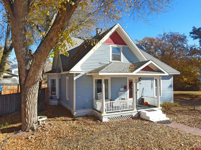 a front view of a house with a yard and porch