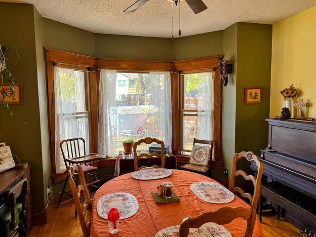 a dining room with furniture a rug and a chandelier