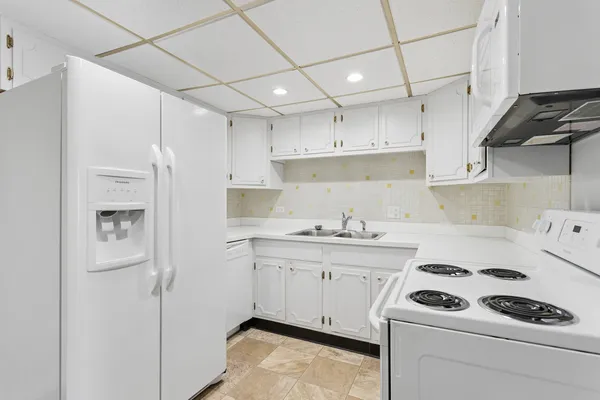 a kitchen with a sink a stove and refrigerator