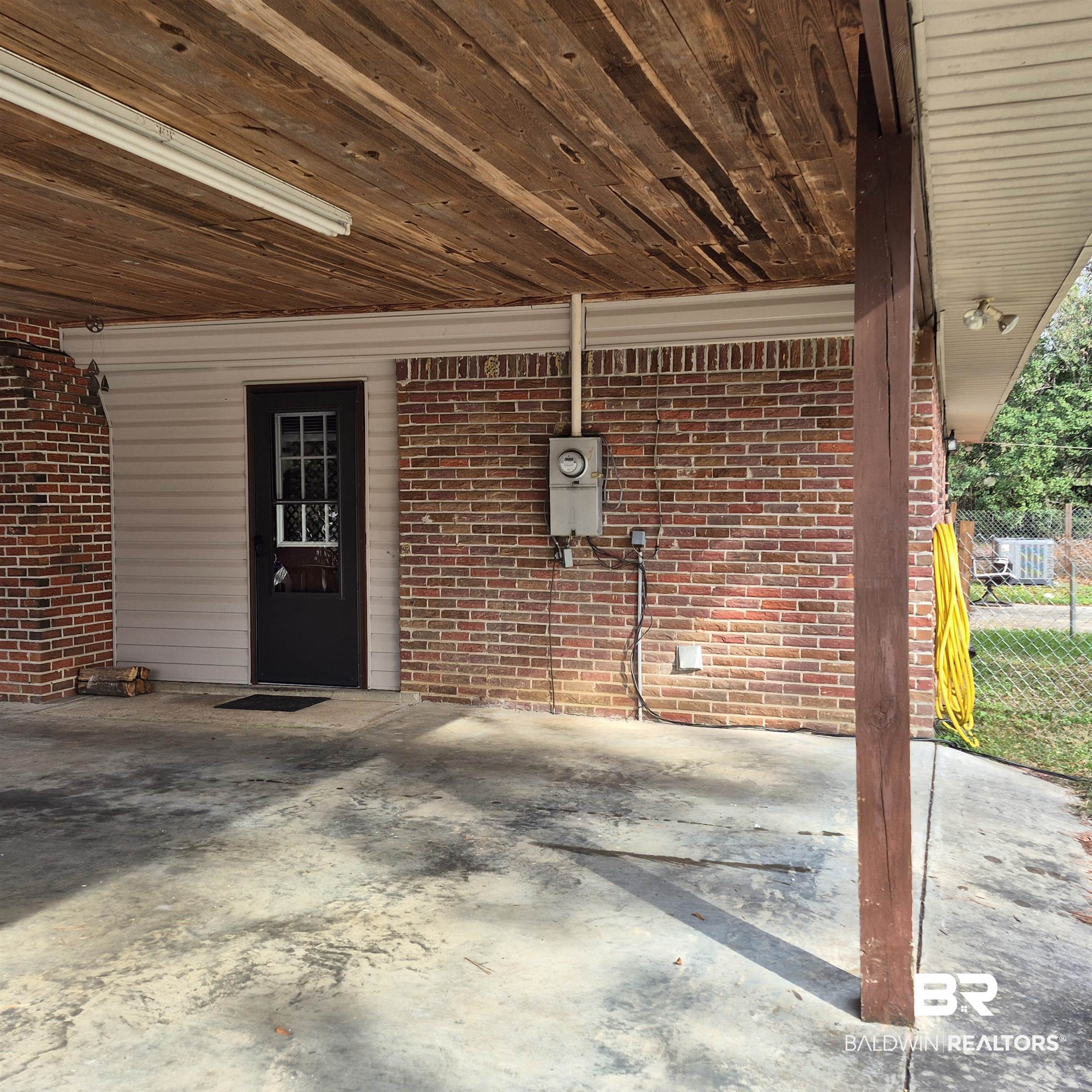 491 Forrest Avenue Castleberry, AL 36432 - Photo 22 of 33 View of exterior entry with a patio and brick siding