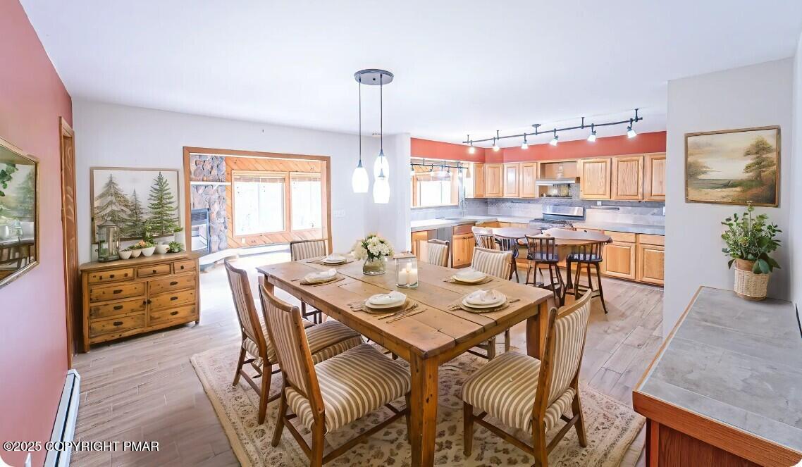 142 Bloss Road Canadensis, PA 18325 - Photo 20 of 109 a dining room with furniture a chandelier and wooden floor