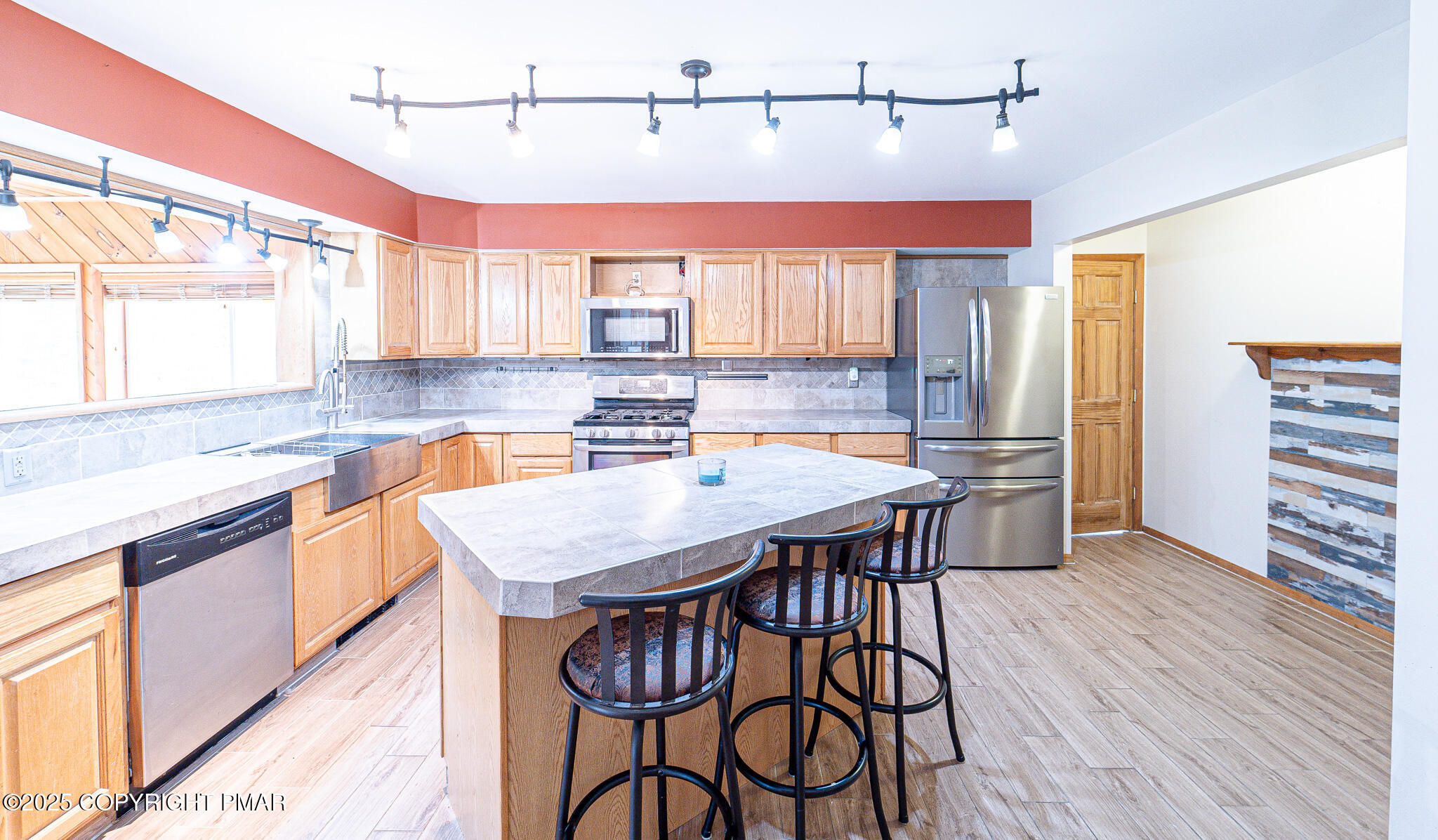 142 Bloss Road Canadensis, PA 18325 - Photo 23 of 109 a kitchen with stainless steel appliances kitchen island granite countertop a table chairs in it and wooden floors