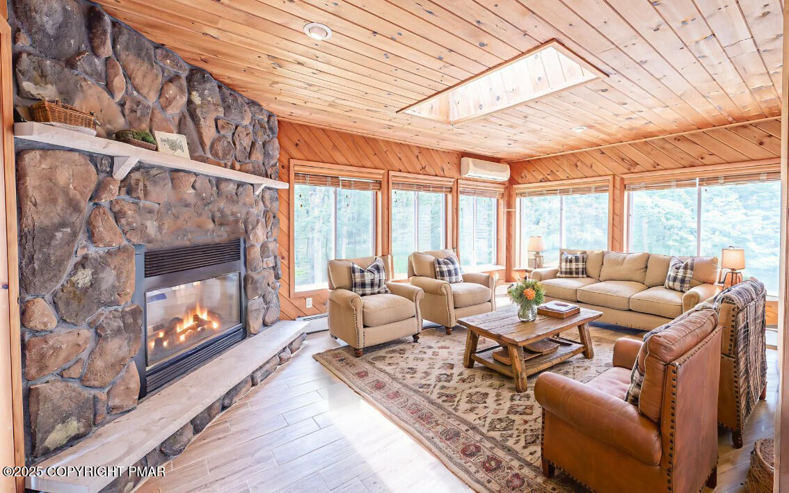 142 Bloss Road Canadensis, PA 18325 - Photo 28 of 109 a living room with furniture a fireplace and a large window