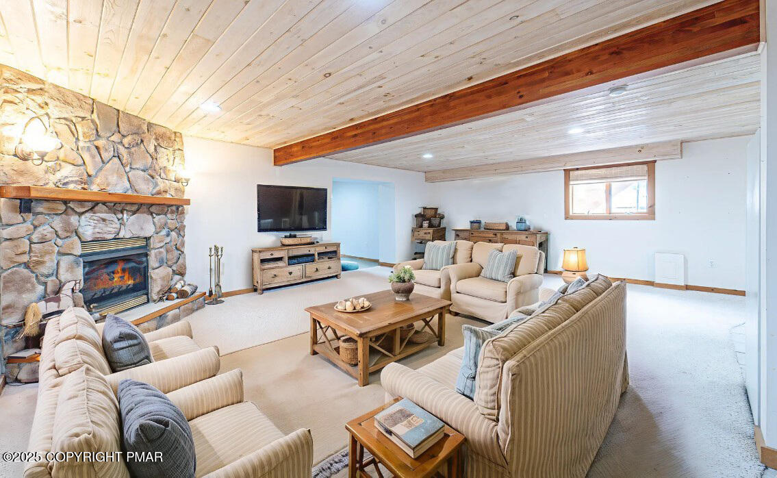 142 Bloss Road Canadensis, PA 18325 - Photo 36 of 109 a living room with furniture a fireplace and a flat screen tv