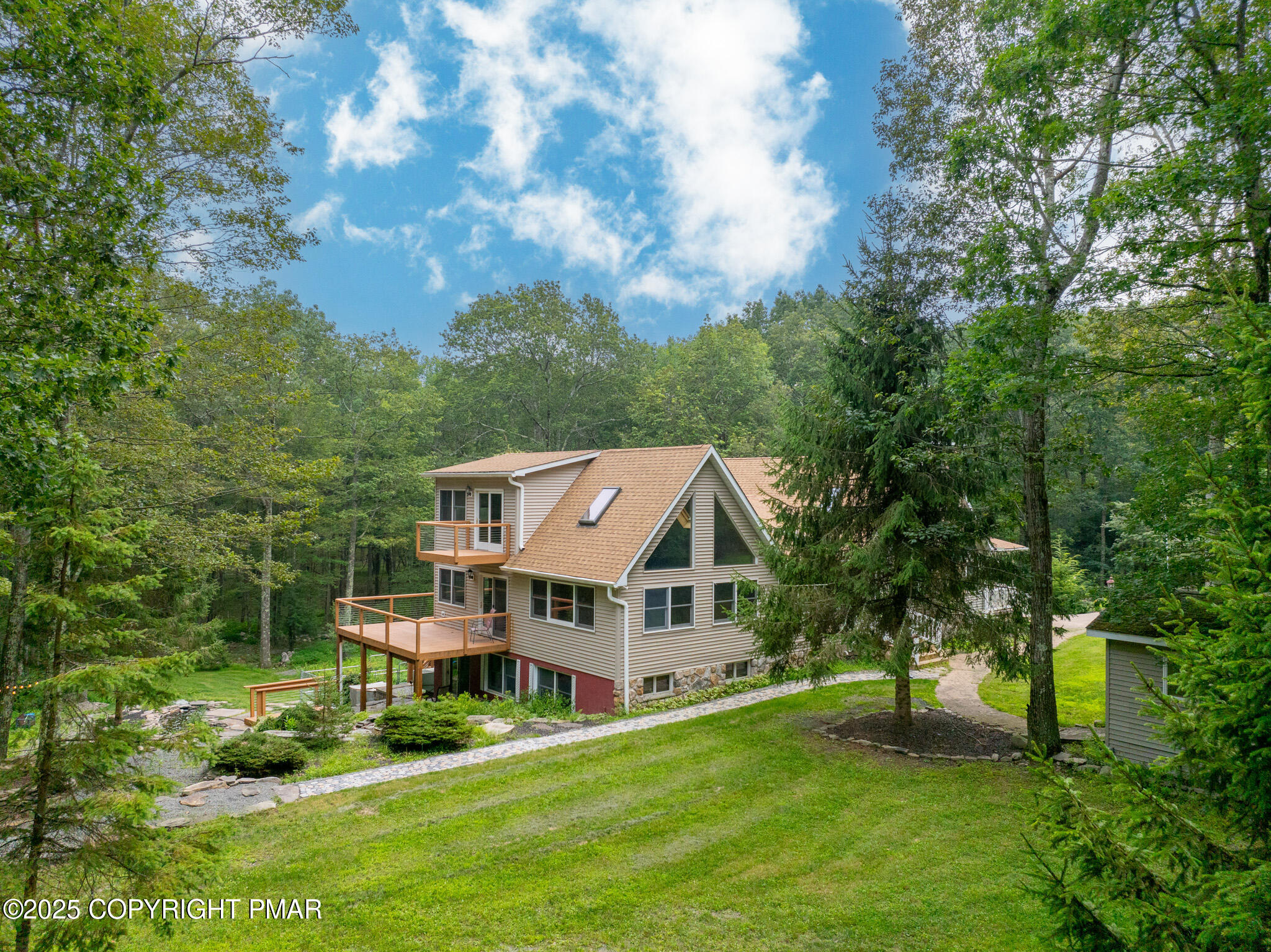 142 Bloss Road Canadensis, PA 18325 - Photo 88 of 109 a aerial view of a house in a big yard with potted plants and large trees