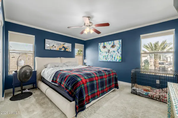 a bedroom with a bed and a chandelier