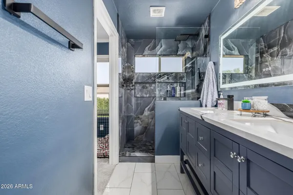 a bathroom with a sink and mirror