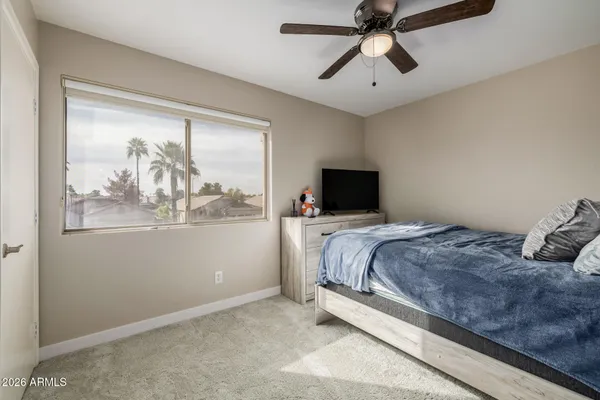 a bedroom with a large bed and a window