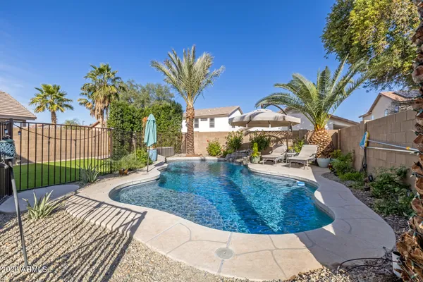 a view of a house with swimming pool patio and swimming pool