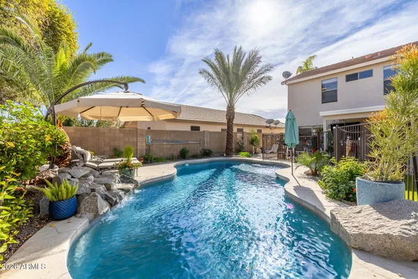 a view of a house with backyard and sitting area