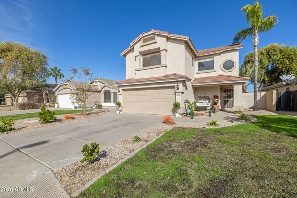 a front view of a house with a garden and patio