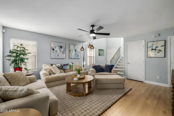 a living room with furniture and a potted plant