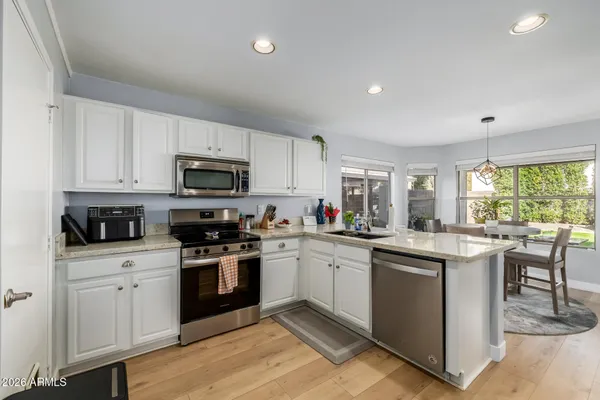 a kitchen with a sink stove and cabinets