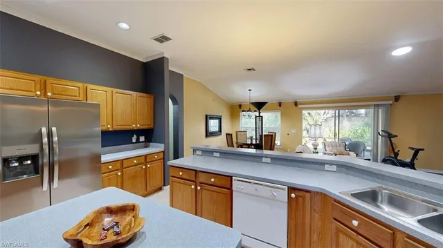 a kitchen with stainless steel appliances granite countertop a sink a stove and a refrigerator