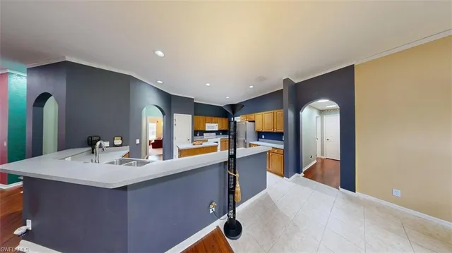 a kitchen with stainless steel appliances a sink stove and refrigerator