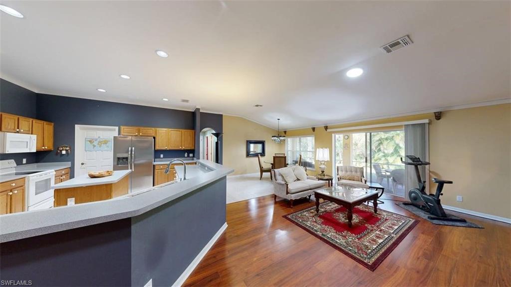 285 Spider Lily Lane Naples, FL 34119 - Photo 24 of 50 a living room with fireplace furniture and a flat screen tv