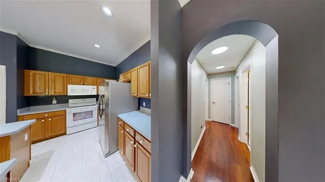 a kitchen with stainless steel appliances granite countertop a sink and a stove