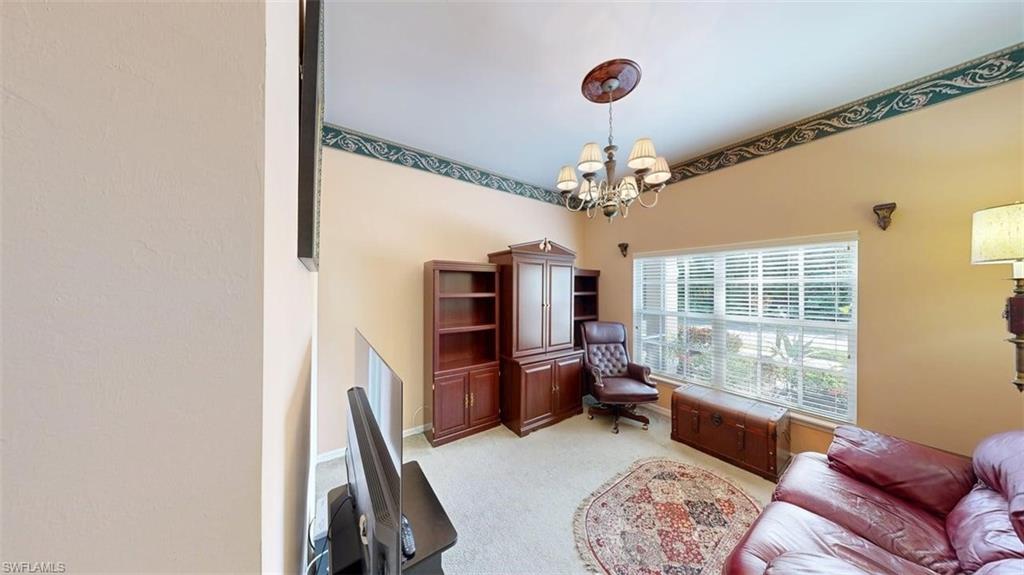 285 Spider Lily Lane Naples, FL 34119 - Photo 30 of 50 a living room with furniture and a chandelier