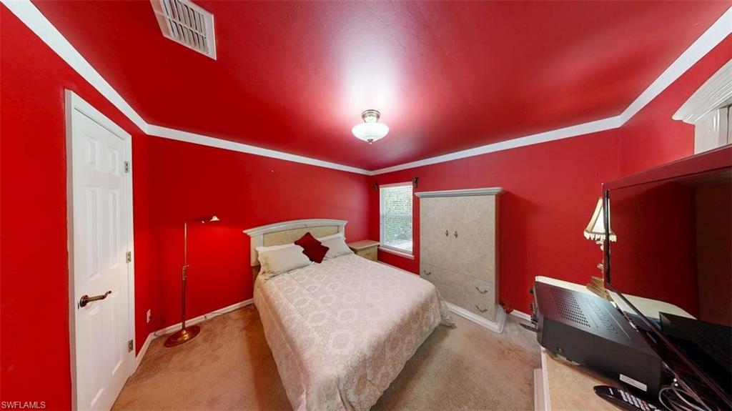 285 Spider Lily Lane Naples, FL 34119 - Photo 40 of 50 a bed room with a bed and a desk