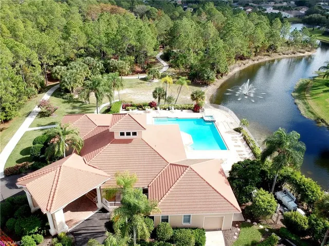an aerial view of a house with a swimming pool and outdoor space
