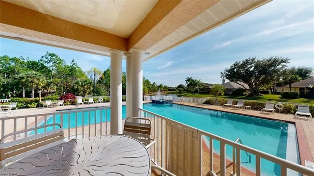 a view of a chair and tables in the balcony