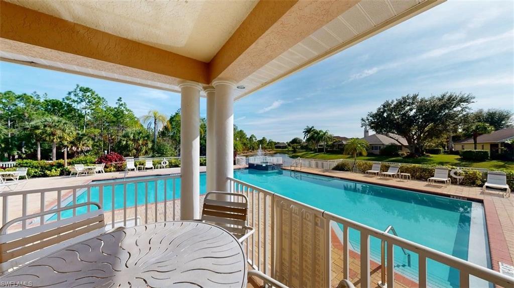 285 Spider Lily Lane Naples, FL 34119 - Photo 7 of 50 a view of a chair and tables in the balcony