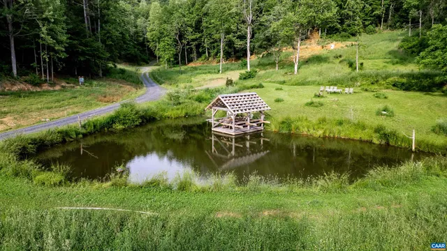 a backyard of a house with a yard and lake view