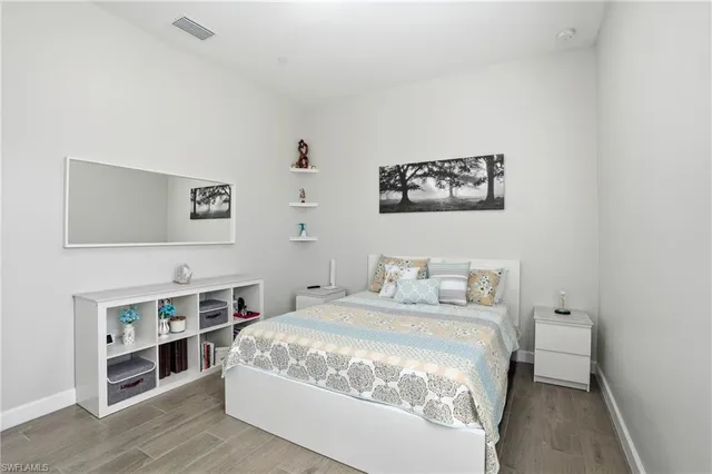 a bedroom with a bed and a book shelf