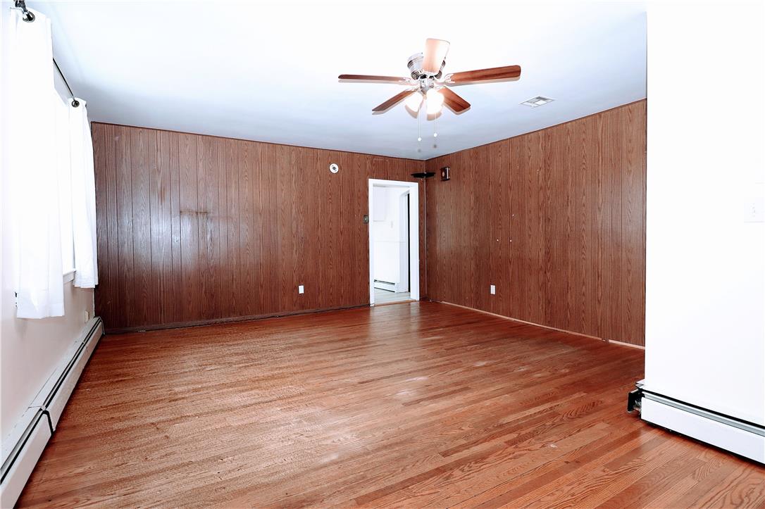 172 Harrison Street Emmaus, PA 18049 - Photo 4 of 30 Hardwood flooring and paneled walls create a welcoming atmosphere in this spacious living area.