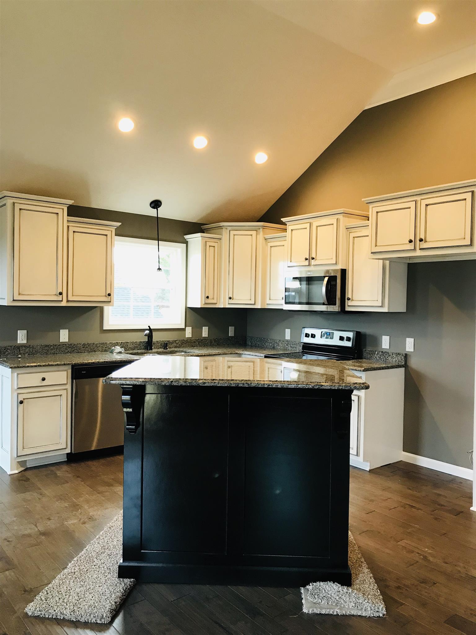 426 Fowler Ford Road Portland, TN 37148 - Photo 3 of 19 a kitchen with stainless steel appliances granite countertop a sink a stove a counter space and cabinets