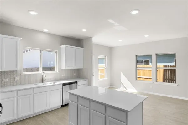 a kitchen with a sink and cabinets