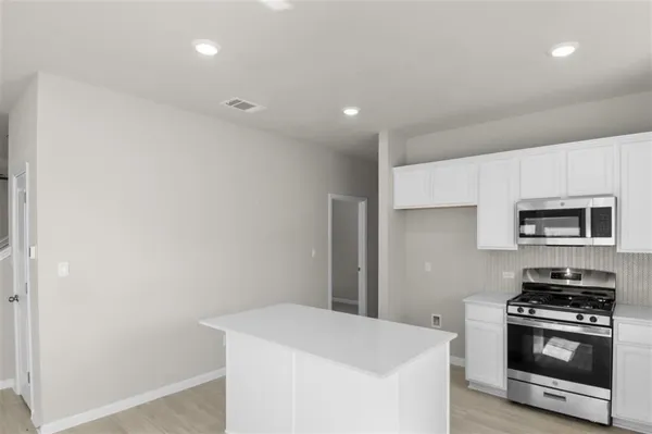 a kitchen with a stove and a refrigerator