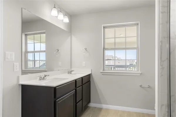 a bathroom with a sink vanity and a mirror