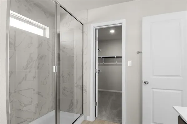 a bathroom with a glass shower door