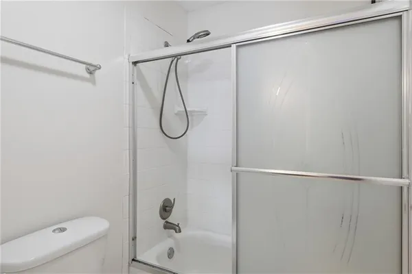 a bathroom with a shower and a toilet