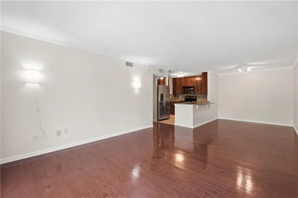a view of a livingroom with a furniture wooden floor and a flat screen tv
