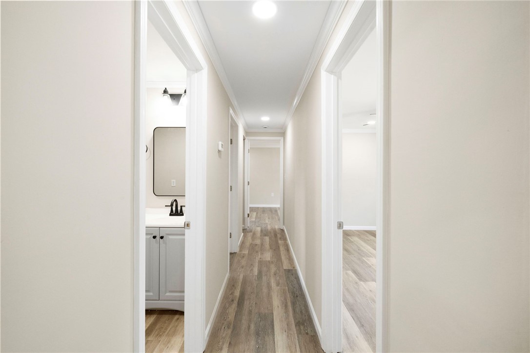 418 Old River Road Pelzer, SC 29669 - Photo 15 of 29 A well-lit corridor with durable plank flooring connects various rooms within this pristine residence.