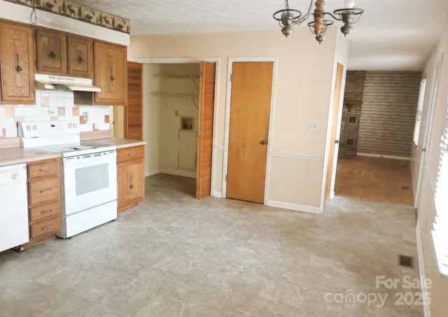 a view of a kitchen with a sink dishwasher a refrigerator and a stove