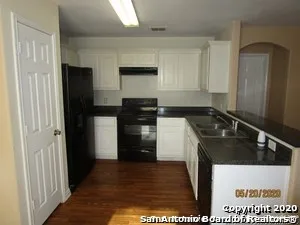 a kitchen with a sink stove and refrigerator