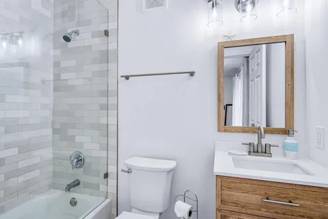 a bathroom with a toilet a sink and mirror