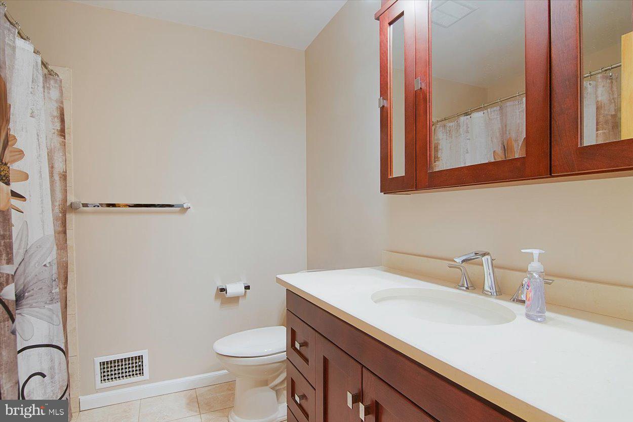 10 Elizabeth Court Edison, NJ 08817 - Photo 12 of 38 a bathroom with a sink a toilet and a mirror